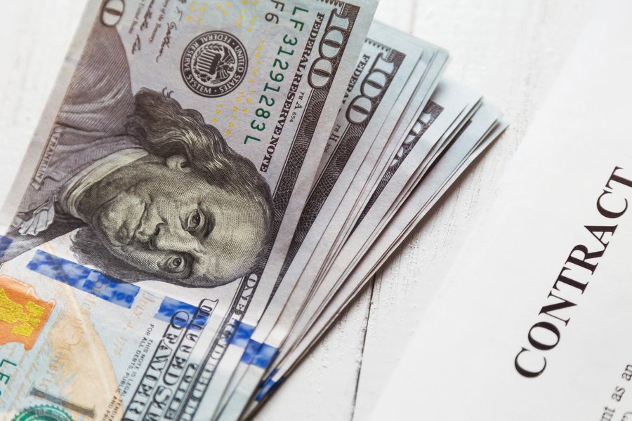 Gym membership contract with cash, representing hidden fees